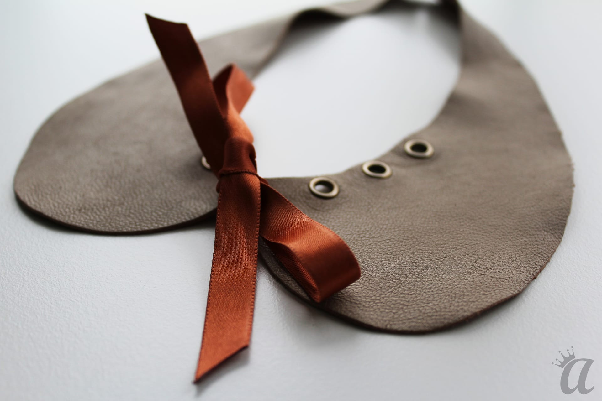 gray leather necklace with brown bow (detail)