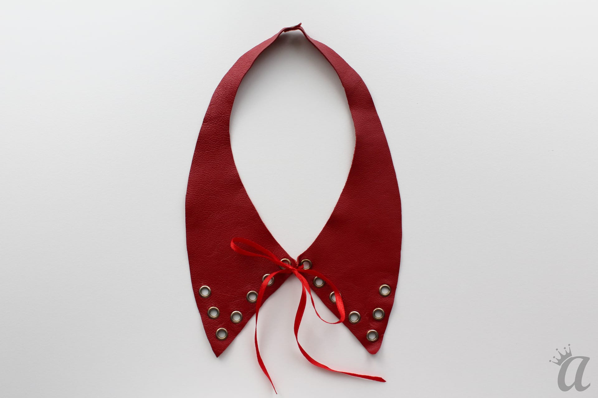 red leather necklace with bow and metallic application